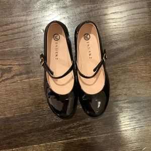 Girls’ black patent leather dress shoes.